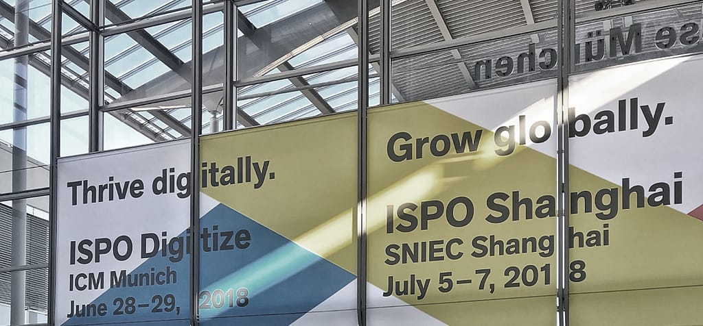 ISPO Digitize and ISPO Shanghai promotional banner in modern trade show atrium.