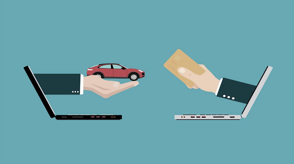 Online car buying transaction with laptop, vehicle, and credit card payment.
