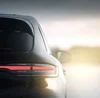 Luxury automotive mobility vehicle rear LED taillight design at sunset.