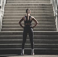 Athlete preparing for sports and leisure workout on urban concrete stairs.