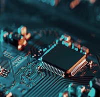 High-tech microchip on circuit board with copper traces and electronic components.