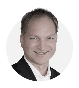 Heiko J. Janssen professional headshot smiling in business suit.