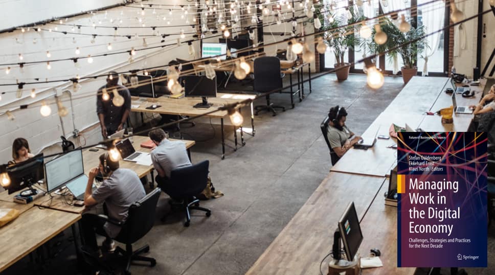 Managing Work in the Digital Economy book cover over modern coworking office workspace.